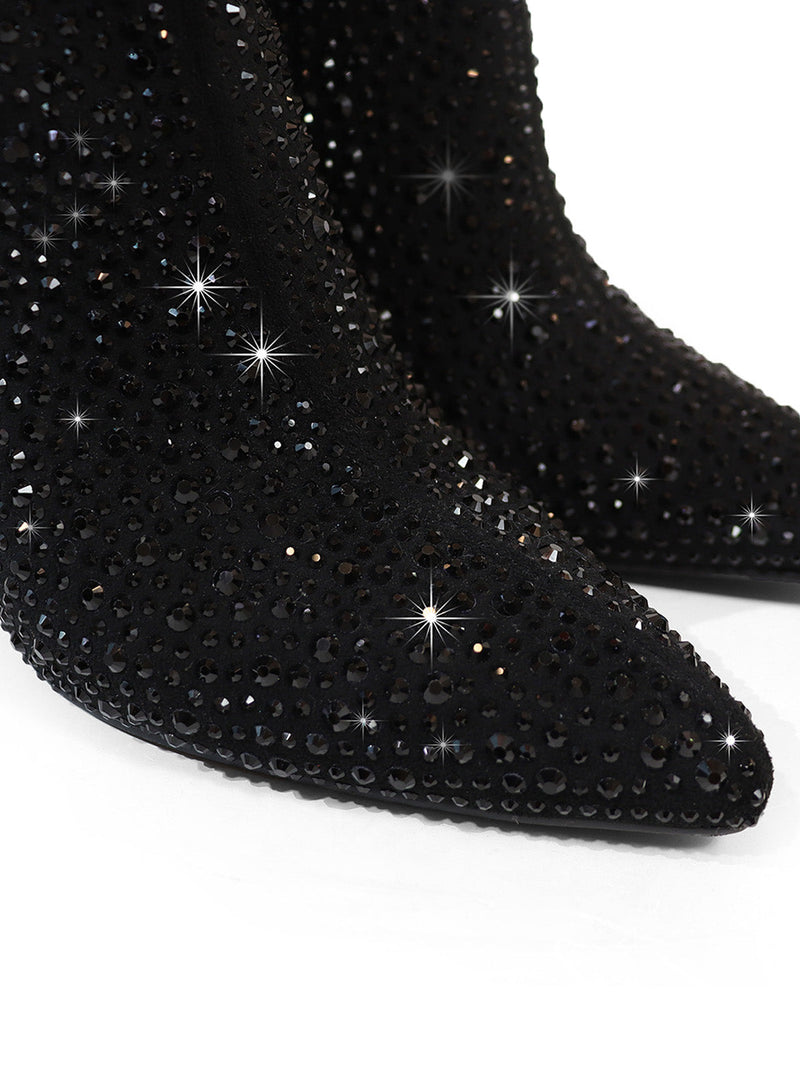 Close-up of Frederick's of Hollywood Izara Rhinestone Ankle Boots, featuring a pointed toe and shimmering black rhinestones, making a bold statement against a white background.