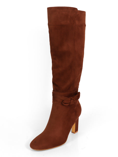 The Janeth Ankle Heel Boots by Frederick's of Hollywood feature brown suede in a knee-high design, highlighted by a rounded toe and a decorative knot bow accent near the ankle. Displayed against a white background, these elegant boots combine classic style with the modern appeal of chunky heels for added comfort and sophistication.