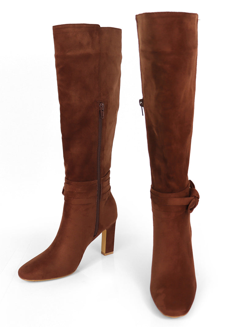 A pair of Janeth Ankle Heel Boots by Frederick's of Hollywood in brown, featuring chunky heels, side zippers, and a decorative strap with a knot detail around the ankle, displayed on a white background.