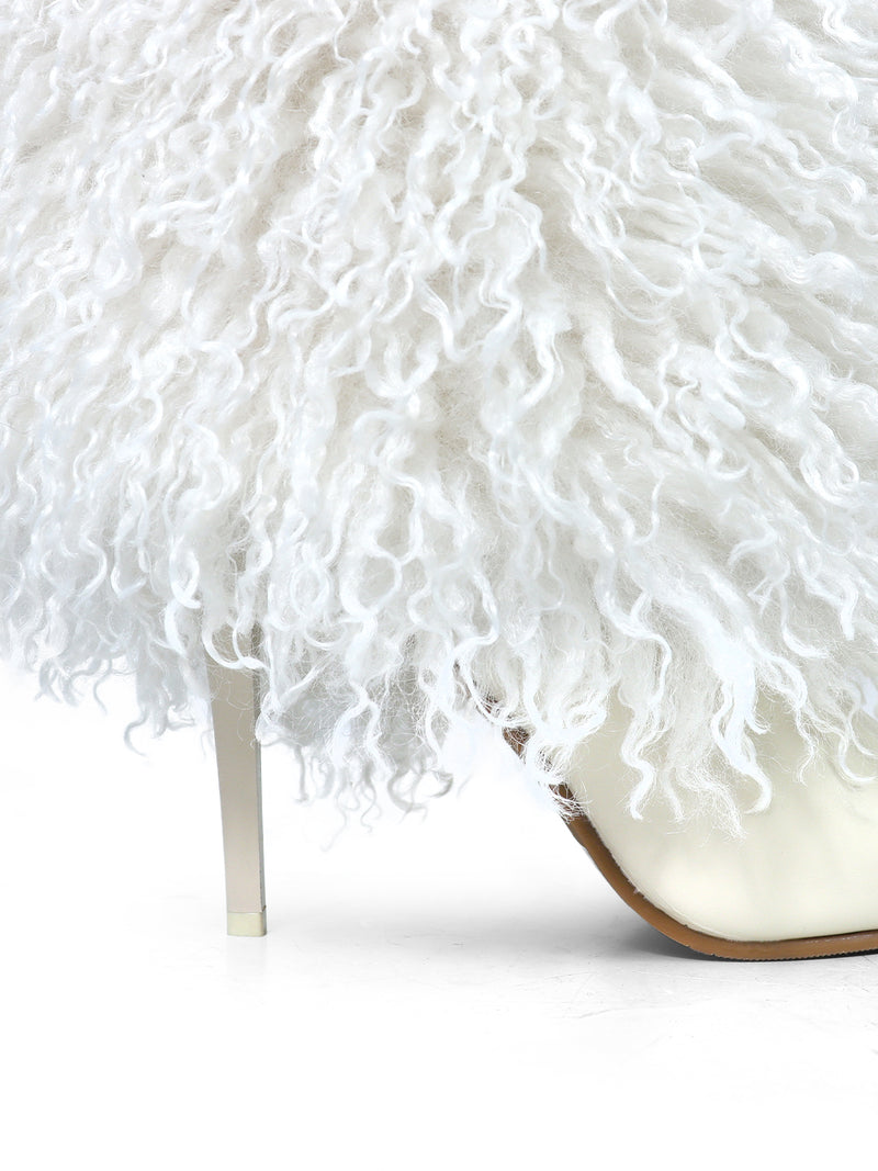 A close-up of the Kiki Pointed Toe Fluffy Boot by Frederick's of Hollywood, featuring a fashion-forward white faux fur covering and a slim white heel, displayed on a white background.