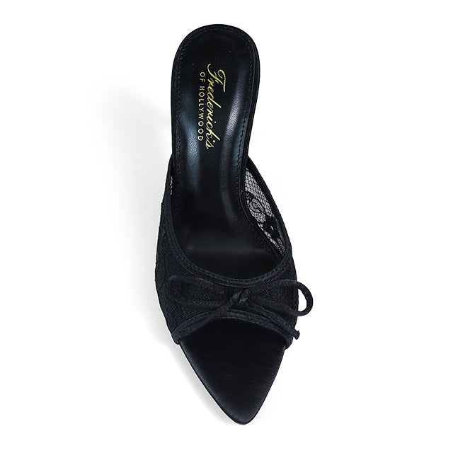 The Lacey Pointed Toe Lace Bow Heels by Frederick's of Hollywood are black mules with a pointed toe, elegant bow detail, lace sides, and gold branding on the insole. Shown from above on a white background.