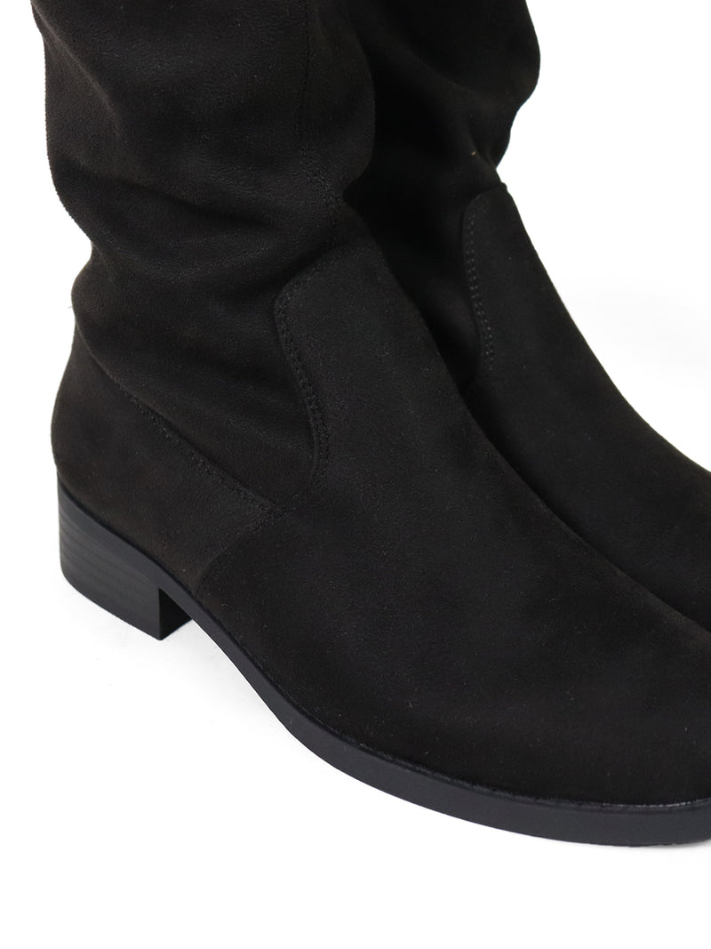 Close-up of a pair of black suede Letizia Thigh High Super Stretch Boots by Frederick's of Hollywood, featuring low heels and shown from the side on a white background.