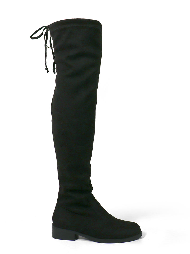 The Letizia Thigh High Super Stretch Boots by Frederick's of Hollywood are black suede over-the-knee boots featuring a low block heel, rounded toe, and a tie closure at the back. Shown in a side profile against a white background.