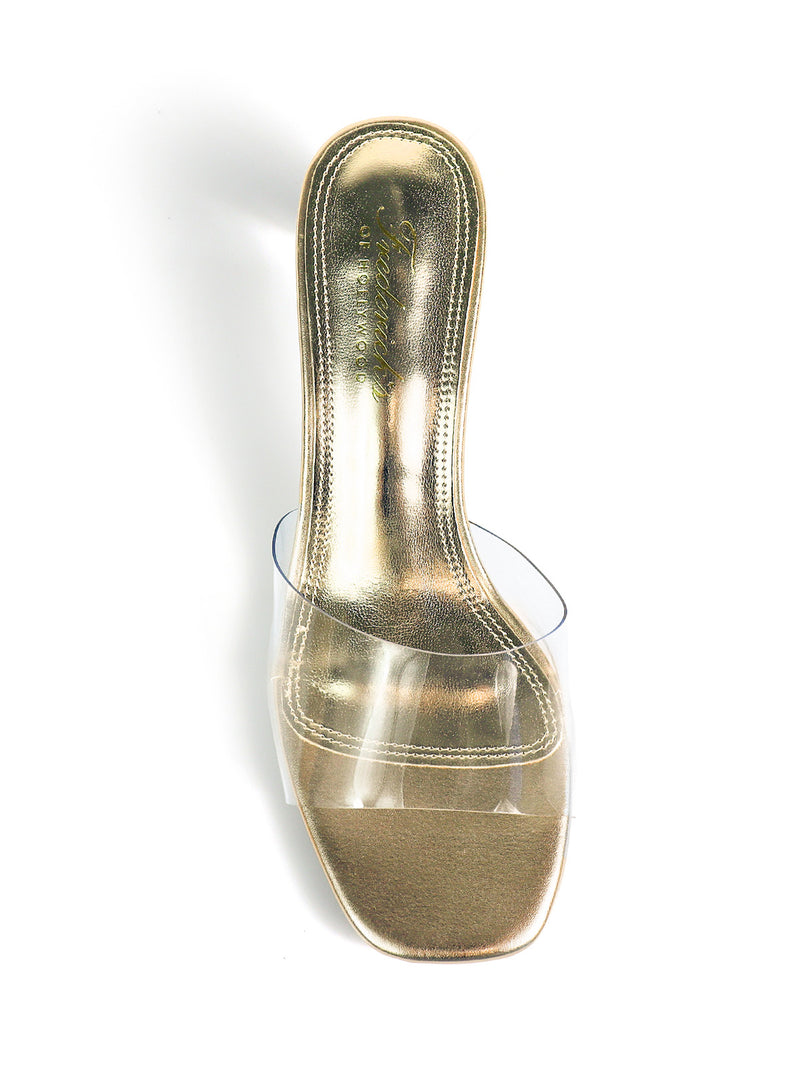 The Lora Transparent Mule Wedges by Frederick's of Hollywood feature gold heels, a square toe, and a clear wide strap in a minimalist style, shown from above on a white background.