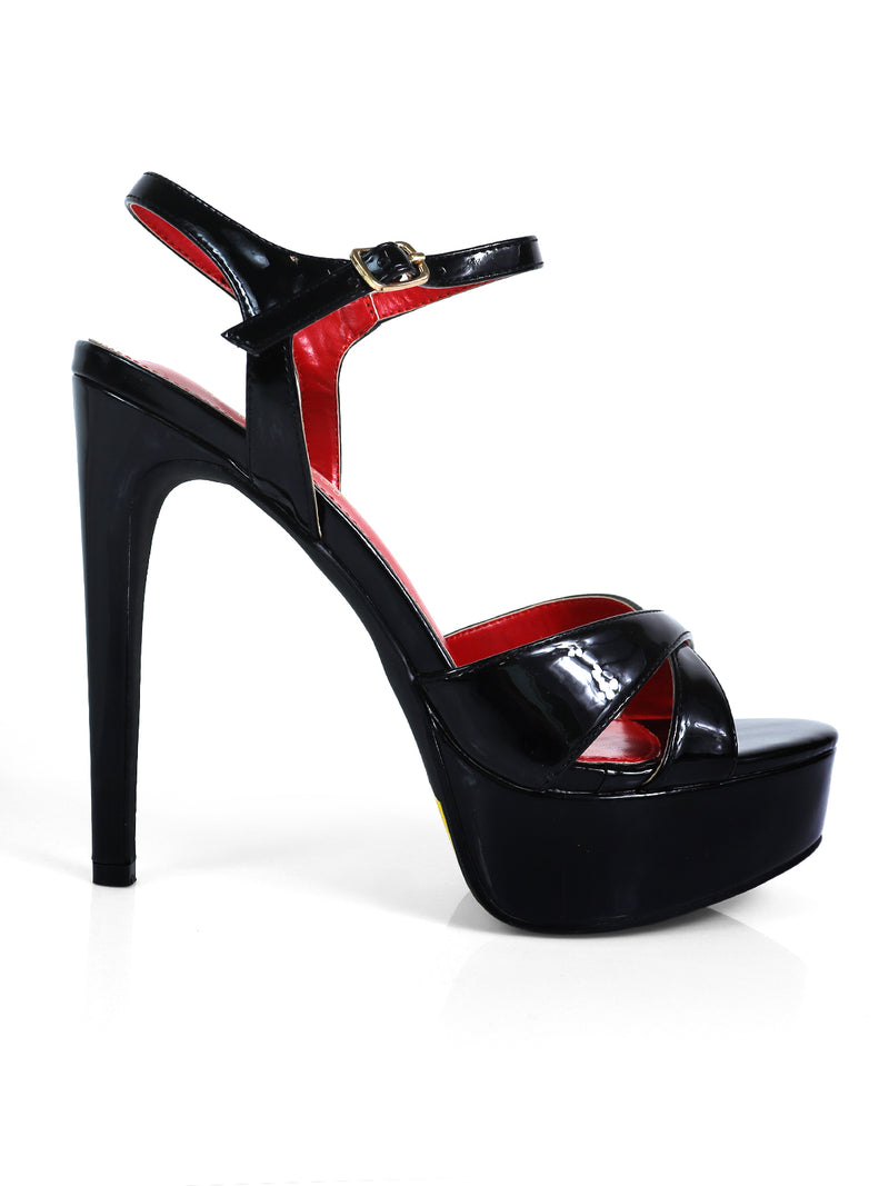 The Madison Ankle Strap Heels by Frederick's of Hollywood are black platform sandals with a crisscross toe design, ankle strap and buckle, and red inner lining—ideal for elegant evening occasions.