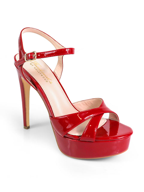 The Madison Ankle Strap Heels by Frederick's of Hollywood feature a shiny red crisscross design, platform sole, glossy finish, and beige insole—versatile statement heels for any occasion.