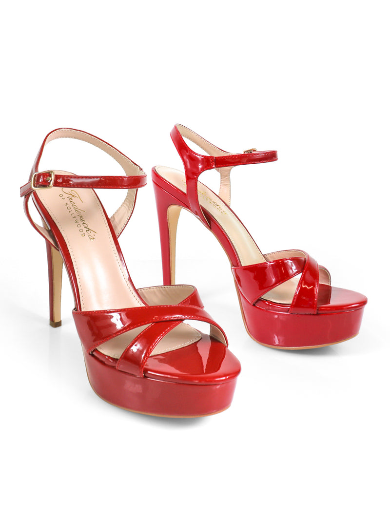 The Frederick's of Hollywood Madison Ankle Strap Heels feature shiny red elegance with platform soles, ankle straps, and open toes, beautifully displayed on a white background.