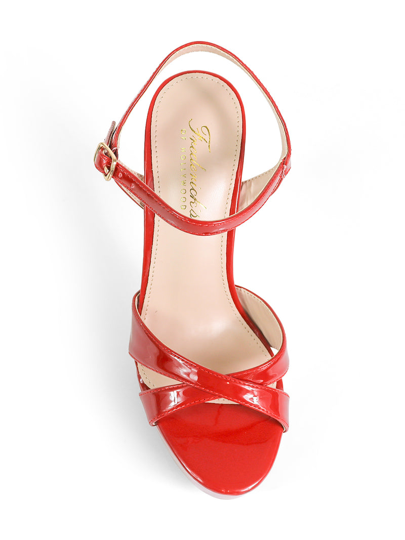 The Madison Ankle Strap Heels by Frederick's of Hollywood feature a single red patent leather design with a crisscross toe strap, shown from above on a white background—an elegant, versatile choice for any occasion.