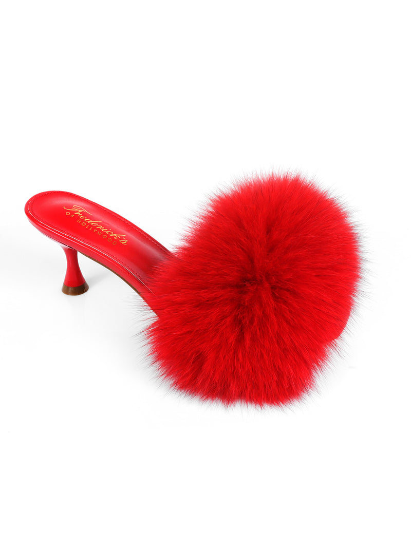 Introducing the Purr Square Toe Fur Heel from Frederick’s of Hollywood—a striking red mule featuring a chic square-toe silhouette and a bold, fluffy pom-pom detail on the front for a truly stylish statement look.