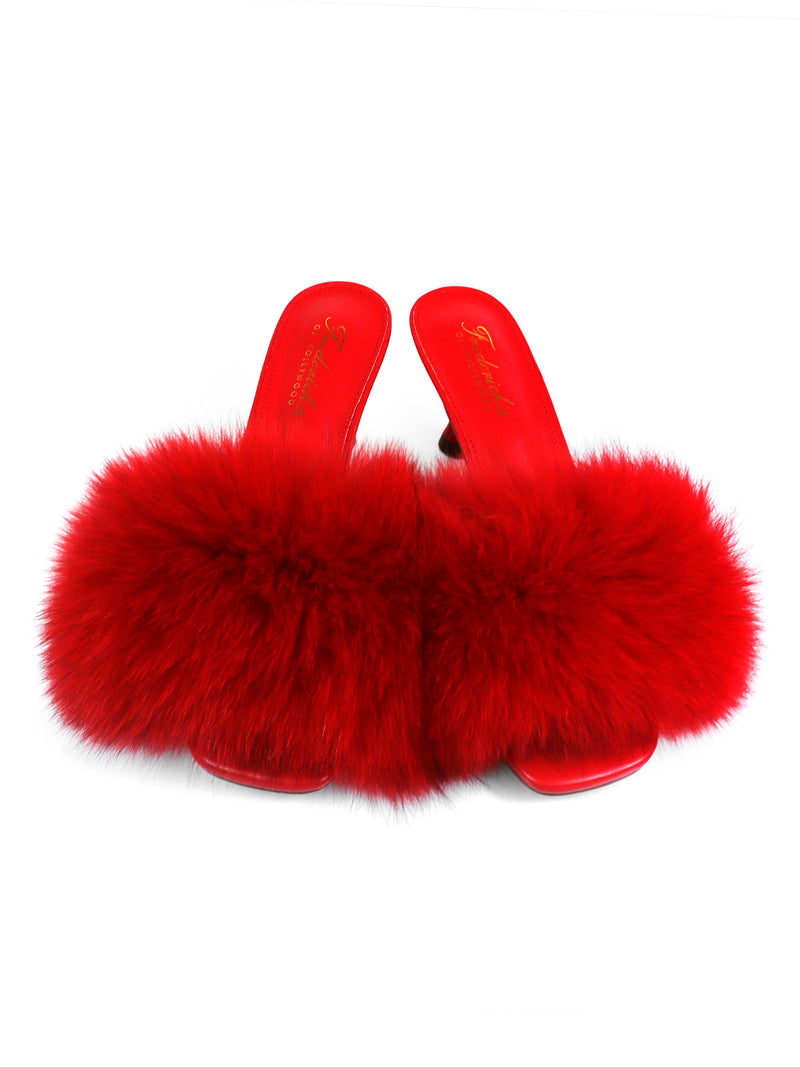 A pair of Purr Square Toe Fur Heels by Frederick’s of Hollywood, featuring red fluffy faux fur straps and a chic square-toe design, displayed on a white background.