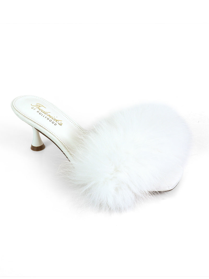 Showcasing the Purr Square Toe Fur Heel by Frederick’s of Hollywood, this stylish white slipper features a fluffy faux fur strap, open toe, slim high heel, and a chic square-toe silhouette, all presented against a plain white background.