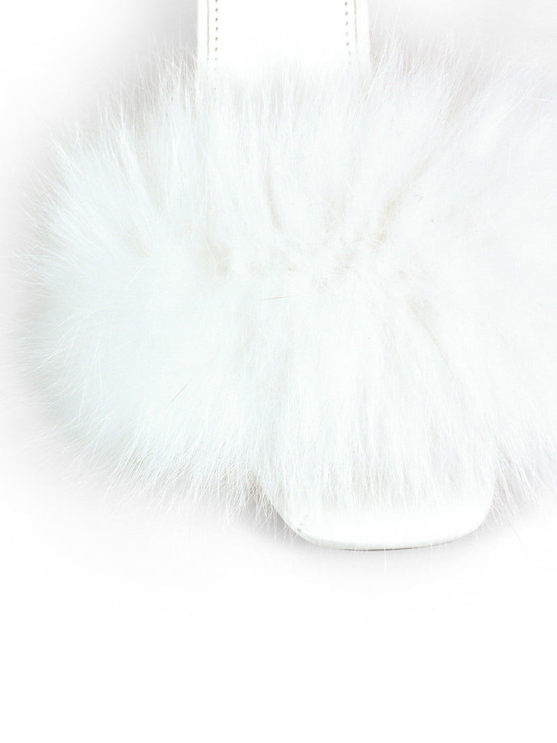 A close-up of the Frederick’s of Hollywood Purr Square Toe Fur Heel, a white slipper featuring a fluffy faux fur strap and a chic square-toe silhouette, shown against a white background.