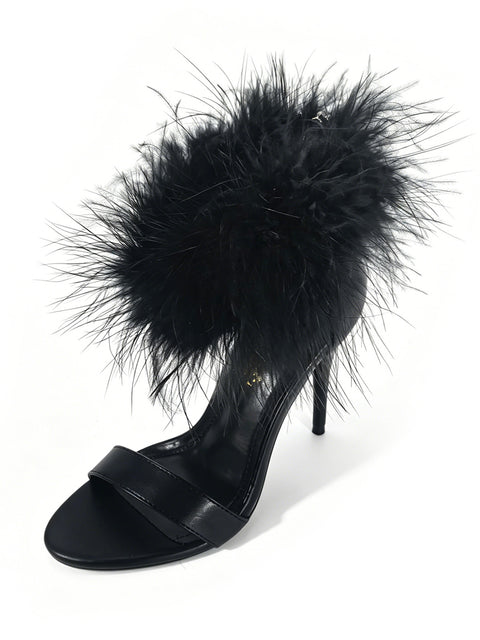 The Raquel Feather Stiletto Heel by Frederick’s of Hollywood features a classic black stiletto silhouette with a sleek toe strap and an ankle strap adorned in soft, black feathers. Set against a white background, this high-heeled sandal highlights elegant feather detailing for a touch of playful sophistication to any ensemble.