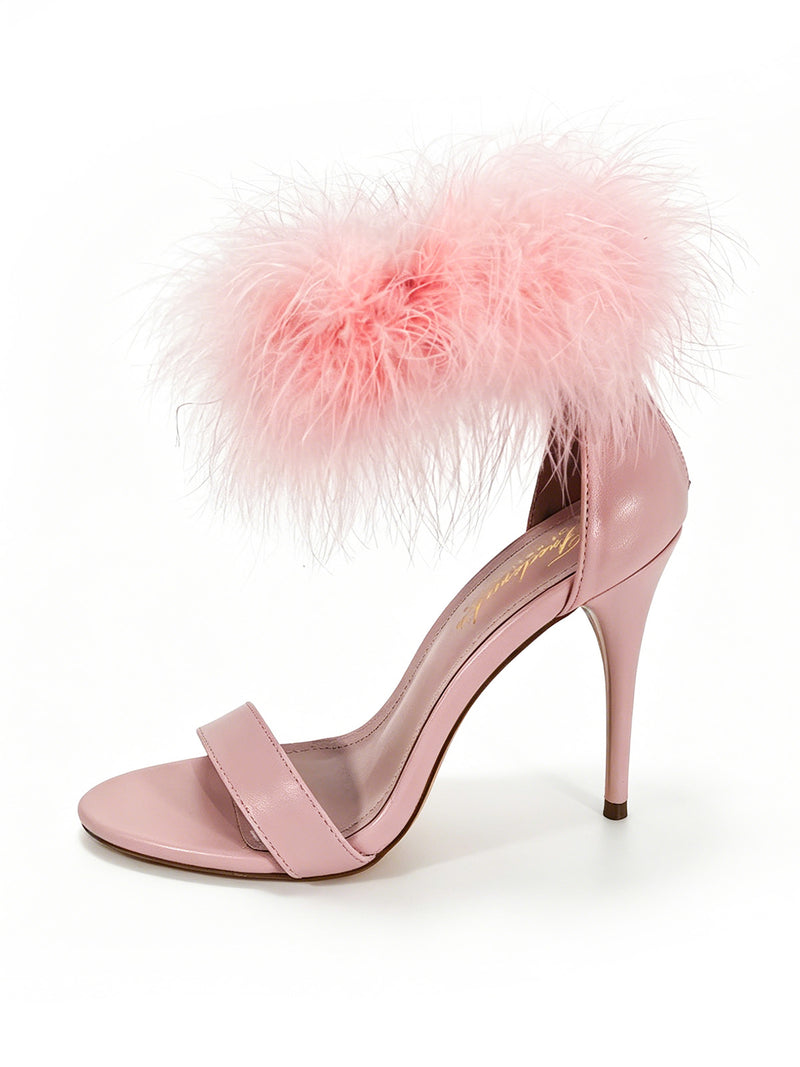 The Raquel Feather Stiletto Heel by Frederick’s of Hollywood is a pink sandal featuring a slender toe strap and sophisticated feather detailing around the ankle strap, ideal for making a statement. Displayed on a white background.