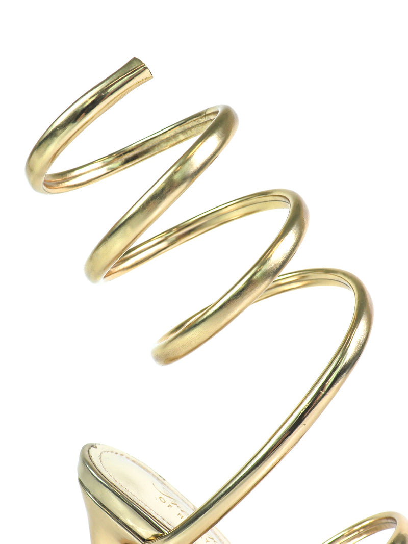 A close-up of the Sabine Round Toe Heel by Frederick's of Hollywood, a gold high-heeled sandal with a spiral ankle strap. This modern, elegant design stands out against a white background for a clean, sophisticated look.