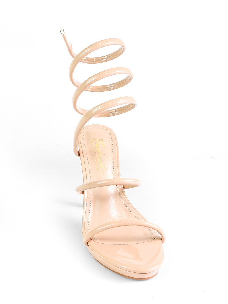 The Sabine Round Toe Heel by Frederick's of Hollywood is a nude patent leather sandal featuring two slim toe straps and a distinctive spiral ankle strap, finished with gold branding on the insole for an elegant touch.
