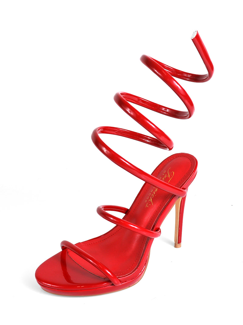 The Sabine Round Toe Heel by Frederick's of Hollywood features a glossy red finish, three slim straps over the round toe and foot, and a striking spiral strap wrapping the lower leg, all showcased against a white background.