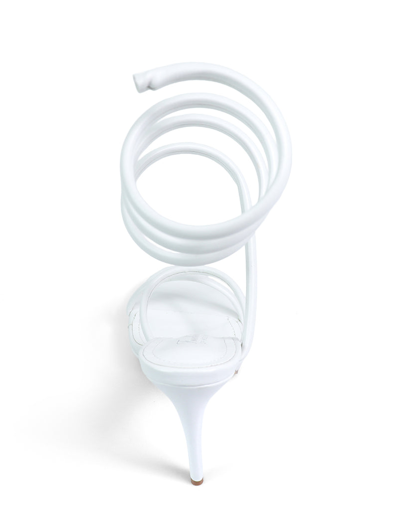 The Sabine Round Toe Heel by Frederick's of Hollywood is a white heeled sandal featuring a unique spiral ankle strap, shown from the back on a white background—an elegant choice to elevate any outfit.