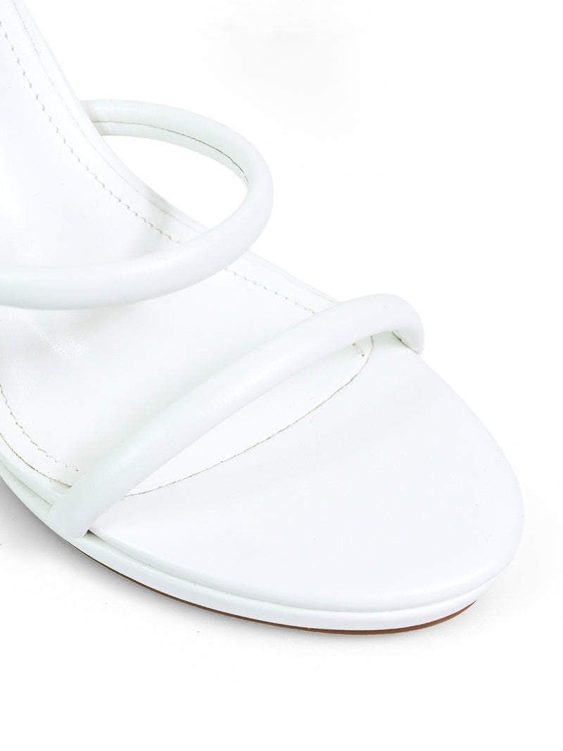 Close-up of the Sabine Round Toe Heel by Frederick's of Hollywood—a white sandal with two thin, curved front straps, a smooth finish, and a minimalistic design for versatile, elegant style.