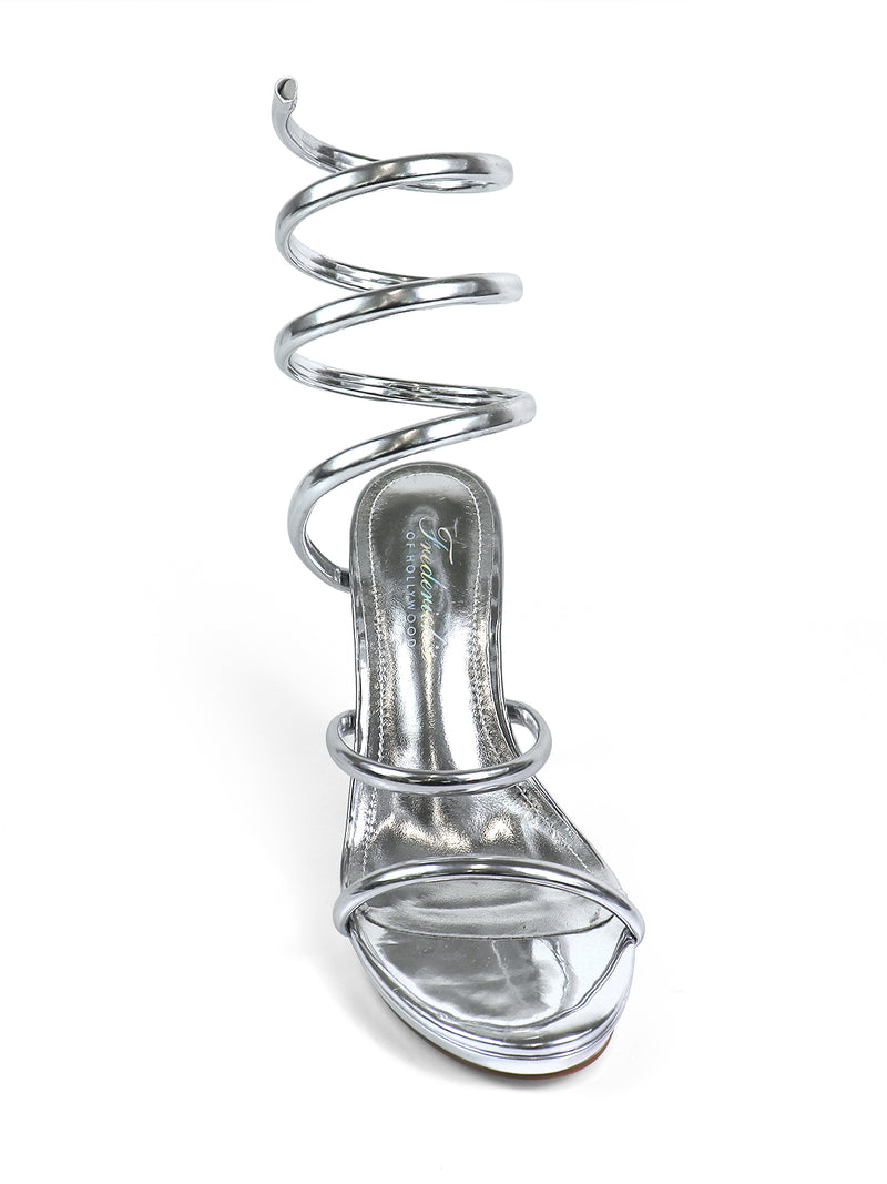 The Sabine Round Toe Heel by Frederick’s of Hollywood features a shiny silver finish, two front straps, and a dramatic spiral ankle strap for an eye-catching, sculptural look—perfect for making a statement at any event.