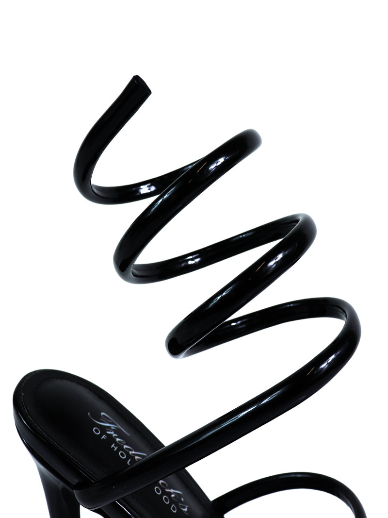 The Sabine Round Toe Heel by Frederick's of Hollywood features a black spiral strap that wraps the ankle, making this elegant sandal a stylish and versatile choice for any women's shoe collection. Displayed against a plain white background.