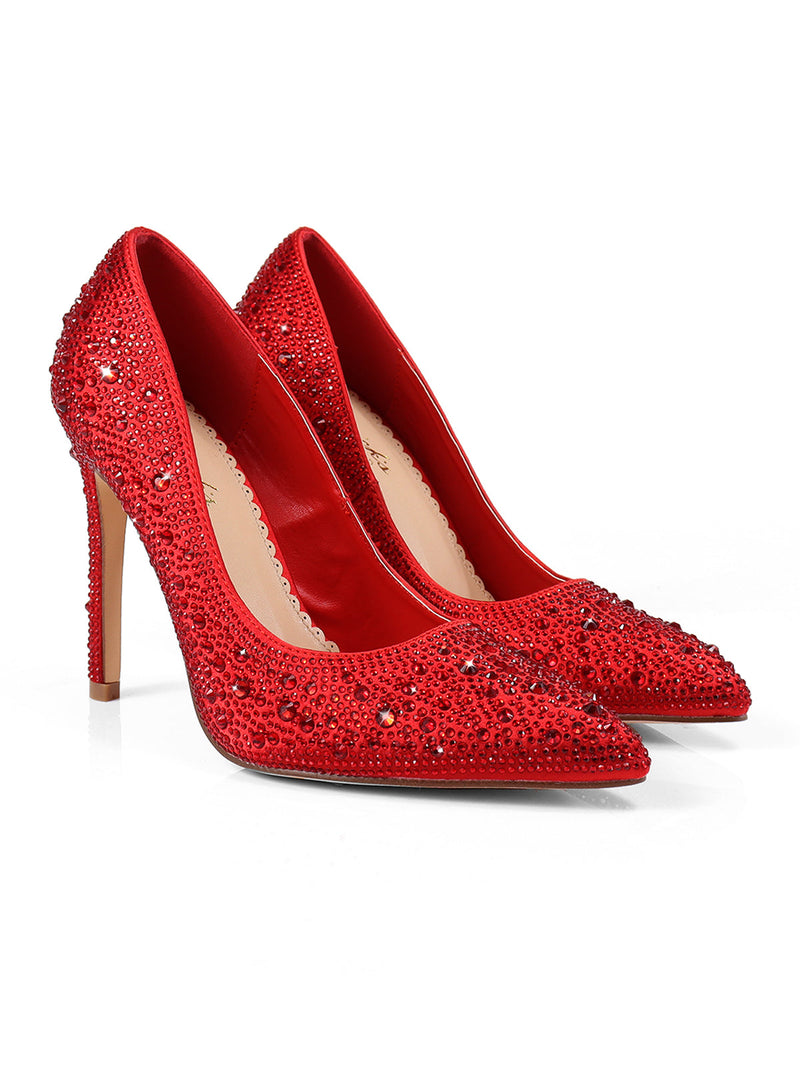 The Samantha Pump by Frederick's of Hollywood is a pair of red luxury heels with sparkling rhinestone details, pointed toes, and stiletto heels, shown against a white background.