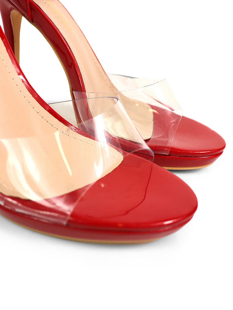 Close-up of Frederick's of Hollywood Stacy Ankle Strap Heels: red elegant heels with clear toe straps and beige insoles. These glossy heels add a chic touch to any outfit.
