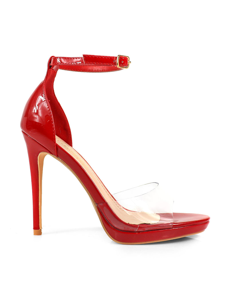 The Stacy Ankle Strap Heels by Frederick's of Hollywood feature a glossy red finish, clear toe strap, adjustable buckle, pointed heel, and tan sole—perfect for chic occasions.