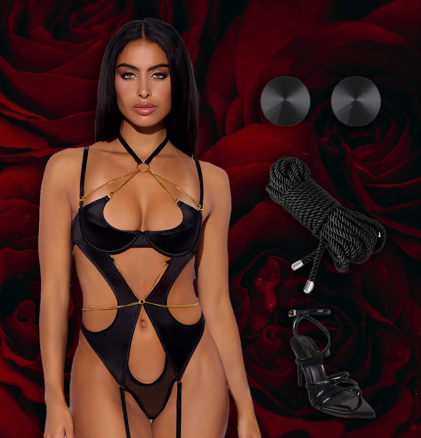 Woman in a black lingerie set with ropes and a whip on a red floral background
