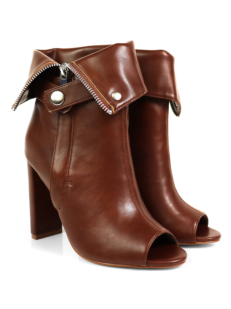 The Yani Folded Ankle Boots by Frederick's of Hollywood are brown leather modern ankle boots with a sleek silhouette, peep toes, folded cuffs with silver buttons, and decorative zippers on the cuffs.