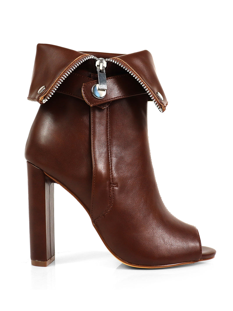 The Yani Folded Ankle Boots by Frederick's of Hollywood feature brown leather, a peep toe, folded cuff, silver zipper and snap detail, plus a chunky heel and tan sole for a modern look.