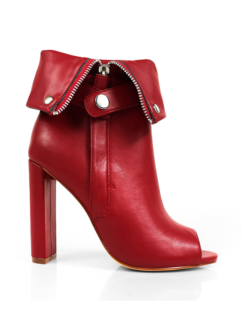 The Yani Folded Ankle Boots by Frederick's of Hollywood are red leather ankle boots with a peep toe, silver snap cuff, visible ankle zipper, and chunky heel for a bold, modern look.