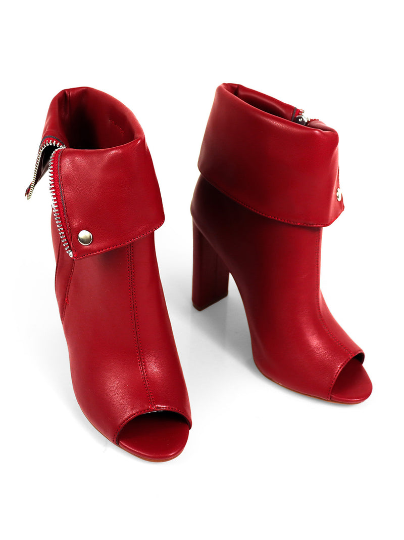 The Yani Folded Ankle Boots by Frederick's of Hollywood are stylish red leather ankle boots with high heels, fold-over cuffs, peep toes, side zippers, and snap button accents, shown on a white background.