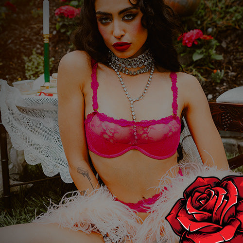 Woman wearing a pink bra and panties with a red rose graphic in the corner.