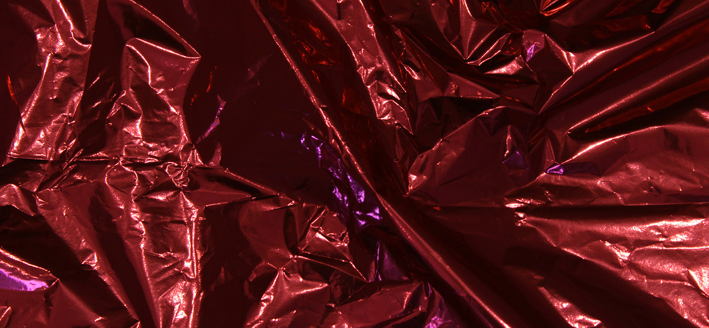 Close-up of crumpled red and purple metallic foil