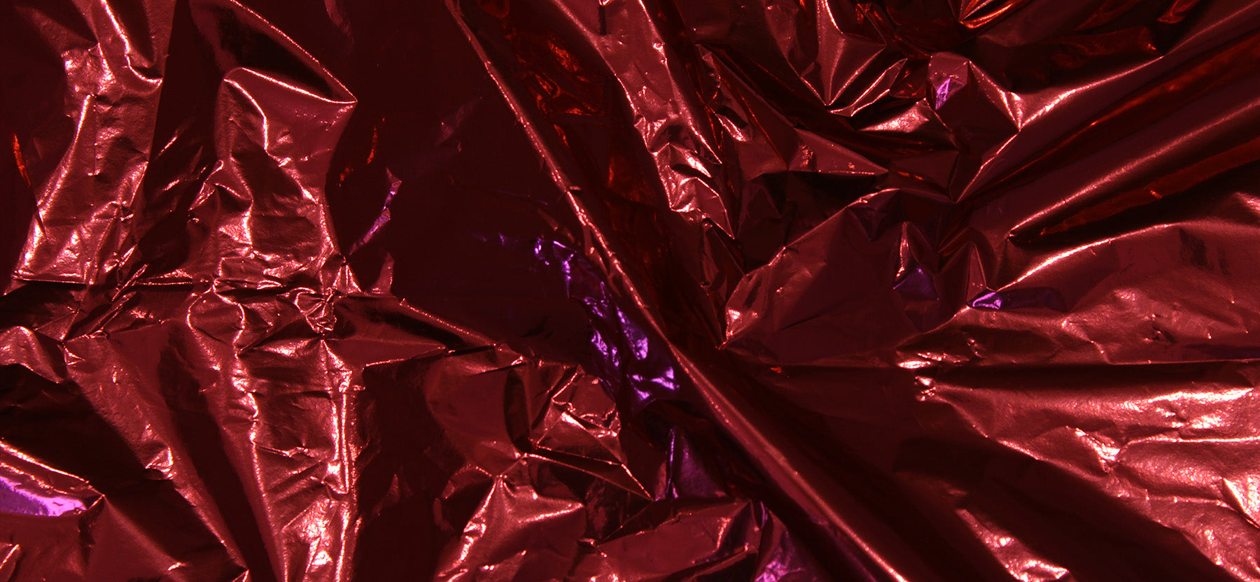 Close-up of crumpled red and purple metallic foil