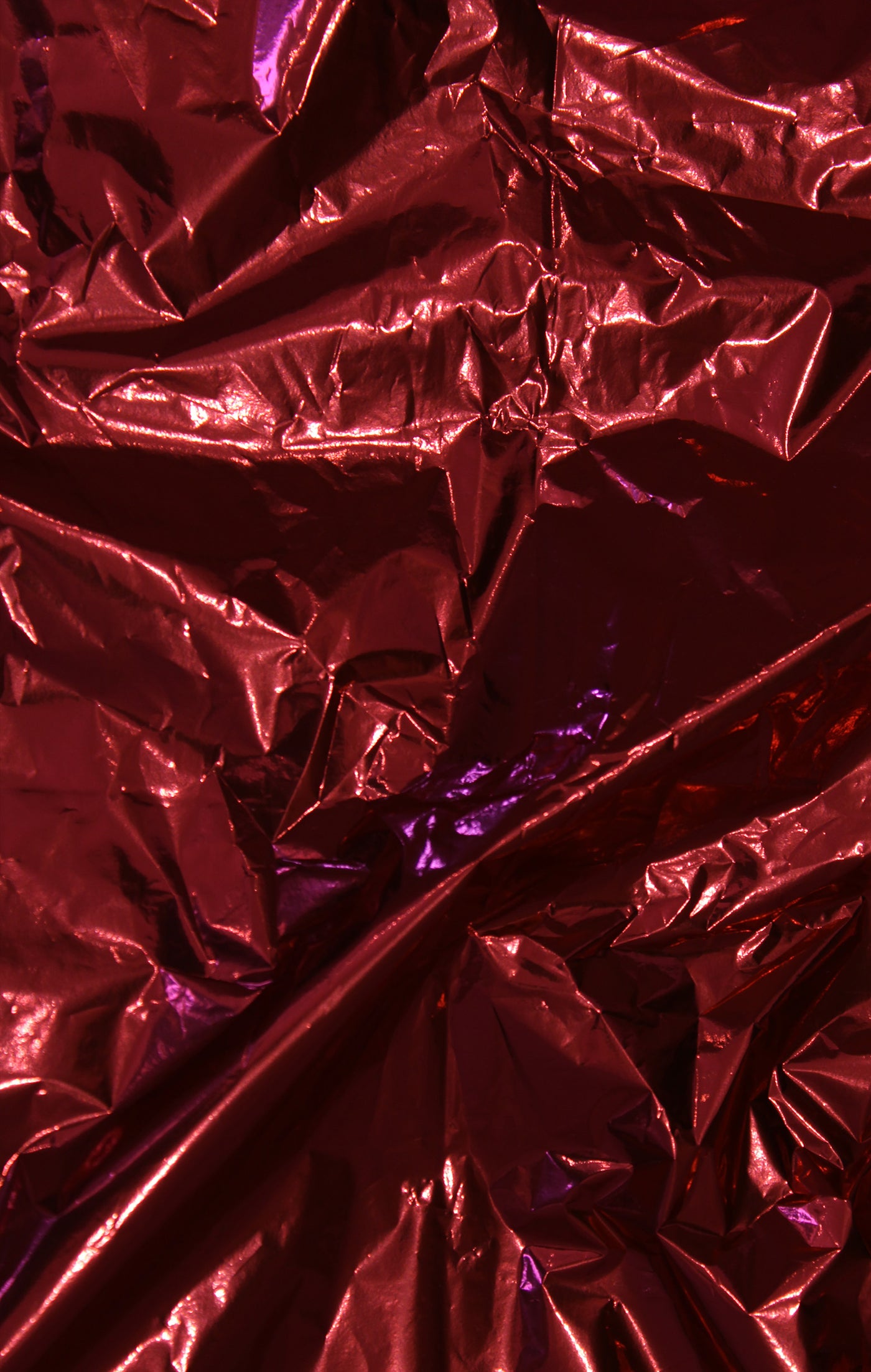 Close-up of crumpled red metallic foil