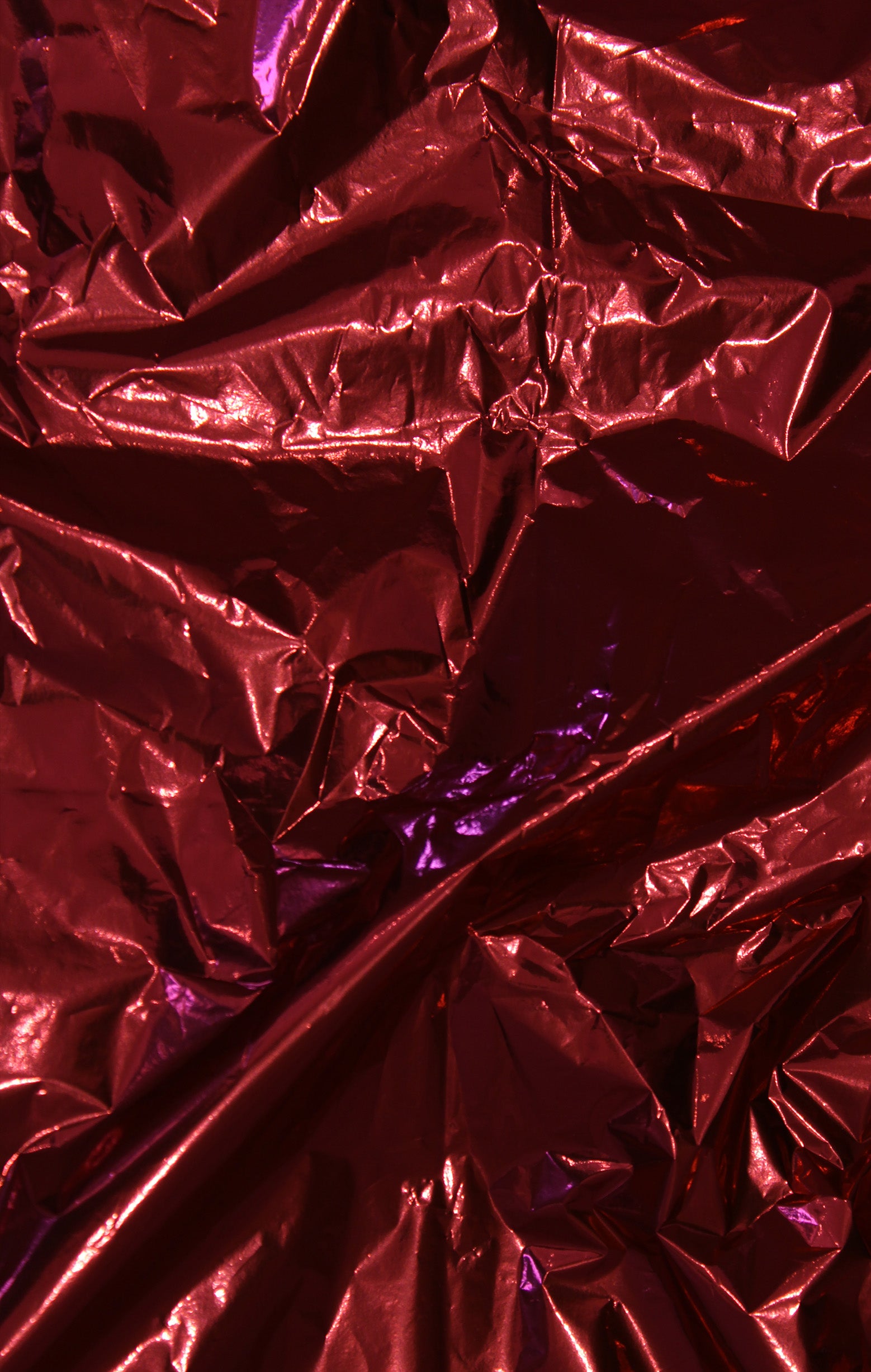 Close-up of crumpled red metallic foil