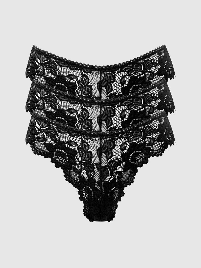 The Jessica Lace Tanga 3 Pack by Frederick's of Hollywood features three pairs of high-waisted, black floral lace panties with minimal coverage, stacked in a staggered arrangement against a plain light gray background.