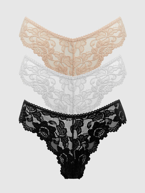 The Jessica Lace Tanga 3 Pack by Frederick's of Hollywood includes three chic minimal-coverage thongs in beige, white, and black—perfect everyday panties displayed overlapping on a light gray background.