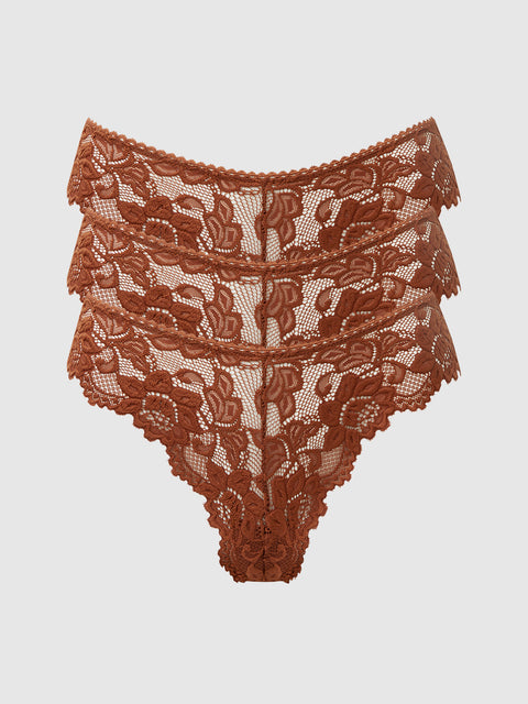 The Frederick's of Hollywood Jessica Lace Tanga 3 Pack features high-waisted, rust-colored underwear with a floral pattern, scalloped edges, and a semi-sheer, minimal coverage design, shown on a plain white background.