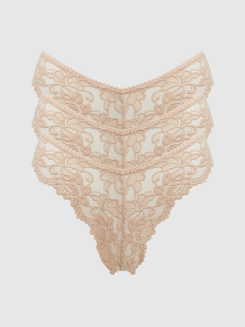 The Frederick's of Hollywood Jessica Lace Tanga 3 Pack features high-waisted, beige floral lace underwear with scalloped edges and minimal coverage, shown against a white background.