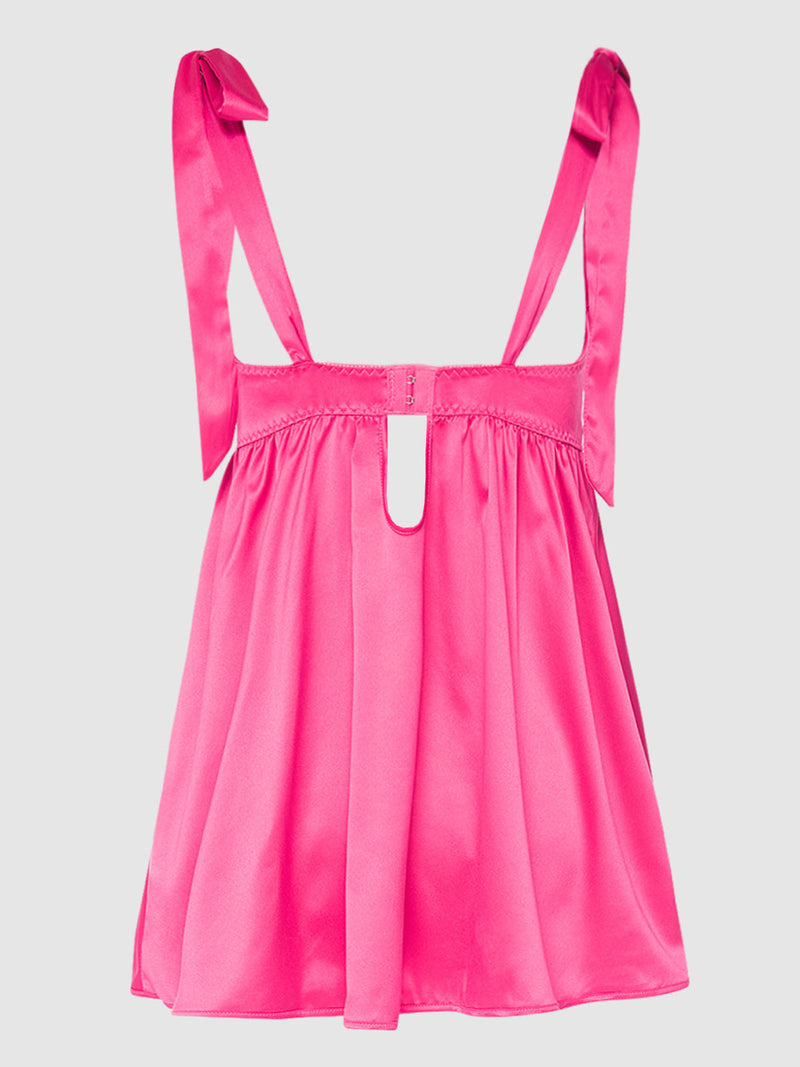 The Petra Satin Open Cup Babydoll by Frederick's of Hollywood features bright pink satin, bow-tied shoulder straps, and a keyhole back cutout—luxurious lingerie, styled on a plain light background and ideal for pairing with a matching G-string.