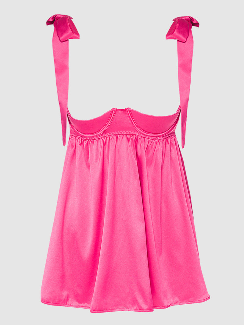 The Petra Satin Open Cup Babydoll by Frederick's of Hollywood features bright pink satin, a fitted bust, loose flowing skirt, and bow-tied straps. This luxurious lingerie is displayed on a plain light background.
