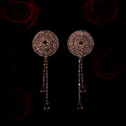 Pair of circular rhinestone pasties with chain details on a dark background