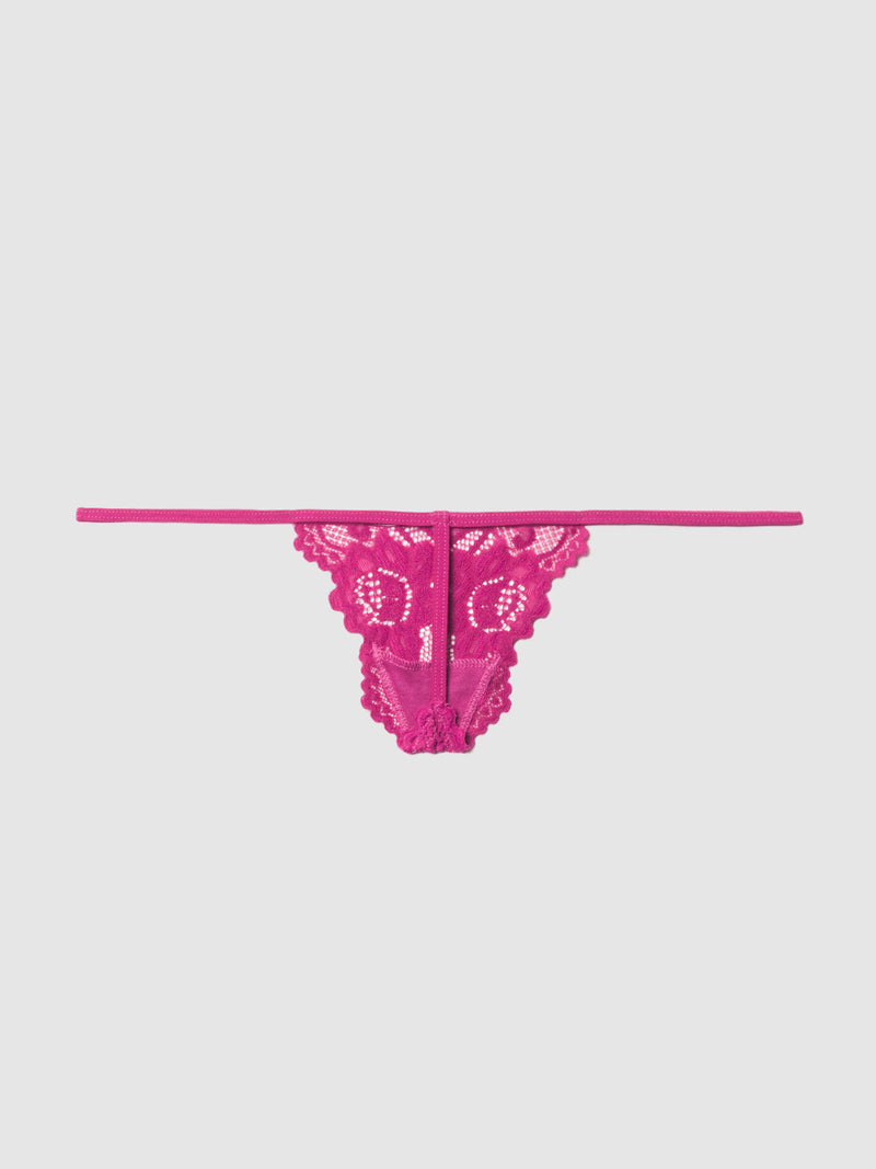 The Frederick's of Hollywood Jessica Lace Mini G-String features a bright pink floral lace pattern, a minimalistic design with thin side straps, and is displayed on a plain light gray background.