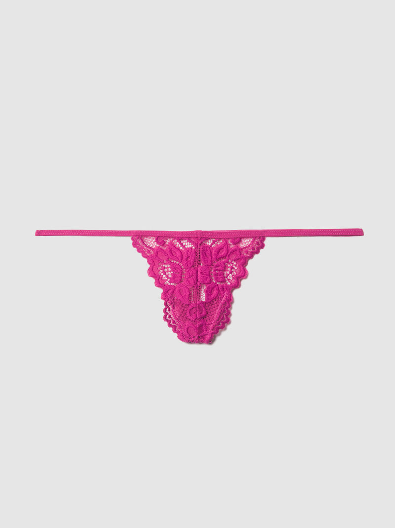 The Frederick's of Hollywood Jessica Lace Mini G-String, in bright pink with floral patterns and a thin waistband, features intricate detailing and is shown on a plain light background.
