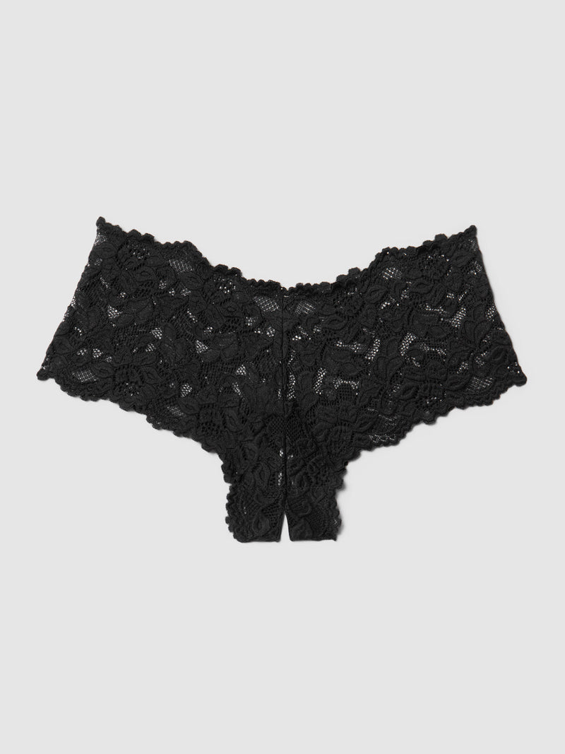 The Jessica Lace Crotchless Cheeky by Frederick's of Hollywood, a sexy black women's underwear with a floral pattern and scalloped edges, is laid flat on a light gray background.