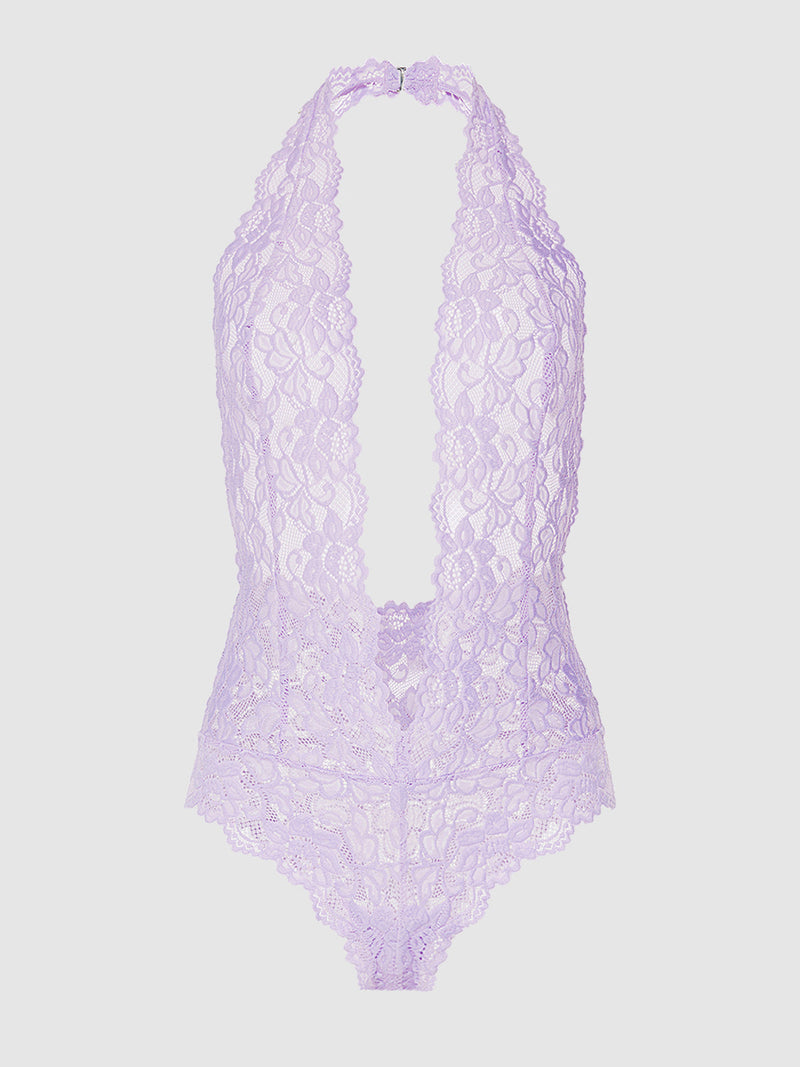 The Jessica Lace Teddy by Frederick's of Hollywood is a light purple, sheer lace halter-neck bodysuit with a deep plunge neckline and scalloped edges, shown on a plain white background.