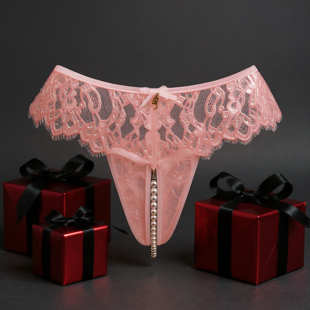 Pink lace thong with pearls with red gift boxes on a dark background